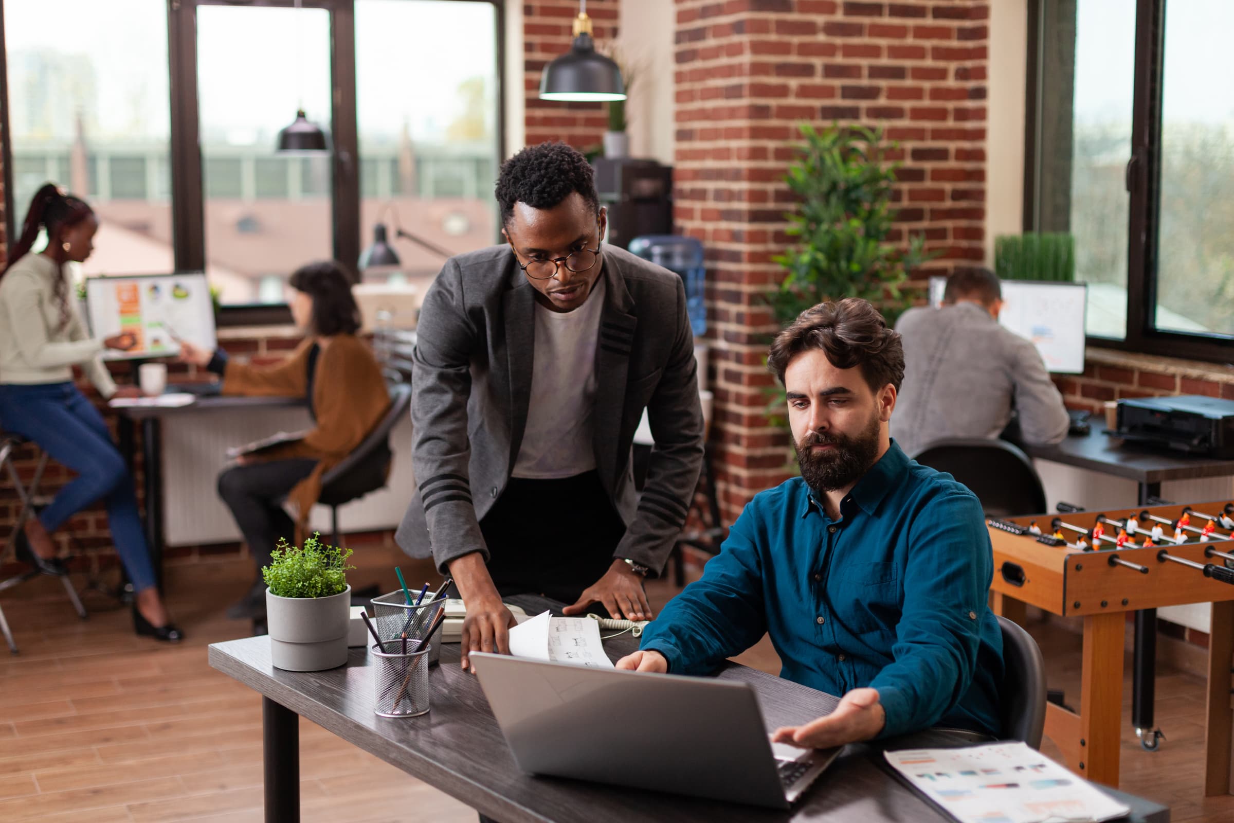 Colleagues working together at a shared desk